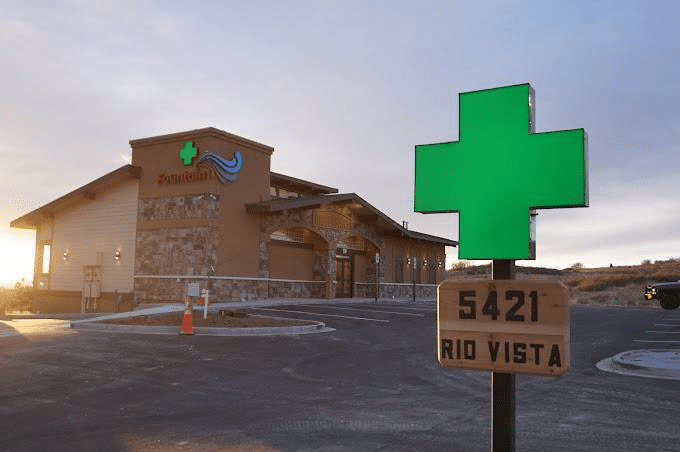 Fountain Superstore dispensary exterior in Colorado Springs, featuring prominent green cannabis leaf sign and address 5421 Rio Vista.
